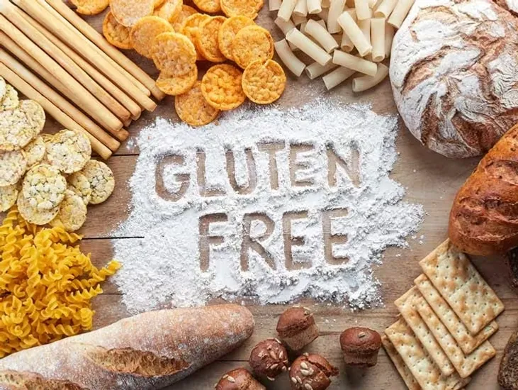 Graphic of food on a table surrounding flour, with the words "GLUTEN FREE" written in the flour