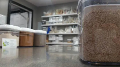 Photo of canisters of food on table and shelves